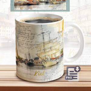 May include: White ceramic coffee mug featuring a watercolor illustration of sailboats in a harbor, with the word "Kiel" in gold. The mug is filled with dark coffee. The design includes script and a rectangular image of the harbor.