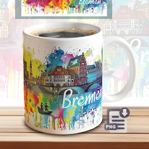 May include: A white ceramic coffee mug featuring a colorful watercolor design of the city of Bremen, Germany, with the city's name in white script. The mug is filled with dark coffee and sits on a wooden surface.
