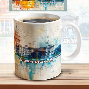 May include: White ceramic coffee mug with a watercolor image of the Washington D.C. skyline. The mug has the text "Washington D.C." and "D.C." printed on it.