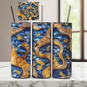 May include: Three stainless steel tumblers with lids and straws. The tumblers feature a blue and gold abstract design with a wood grain pattern.