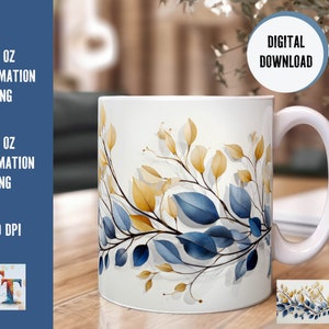 May include: White ceramic mug featuring a watercolor design of blue and gold leaves. The mug has a curved handle and the text "DIGITAL DOWNLOAD" is visible. The image also includes text indicating the mug is available as an 11 oz and 15 oz sublimation PNG.