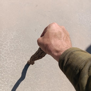 May include: A white ceramic mug with a black handle and the text "But First, Coffee" in a bold, black font. The mug is sitting on a white surface. The mug appears to be 12 ounces.