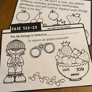 May include: Black and white printable activity sheet with a detective theme. The sheet includes a detective character, a bowl of fruit, and the text "Case 522-23" and "The Fruit of the Spirit".