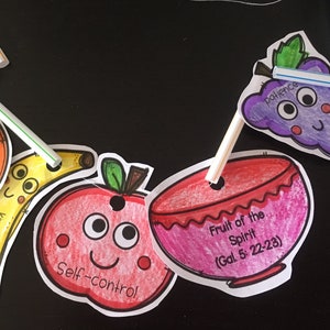 May include: A colorful fruit-themed garland with a bowl that says "Fruit of the Spirit (Gal 5: 22-23)" and individual fruits with words like "faithfulness", "kindness", "self-control", and "patience".