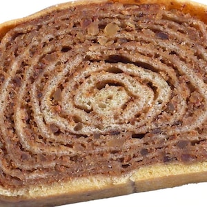 May include: A cross-section of a nut roll pastry, showcasing a spiral pattern of layers. The pastry has a golden-brown crust and a filling of finely chopped nuts and spices. The image is a close-up, highlighting the texture and detail of the baked good.