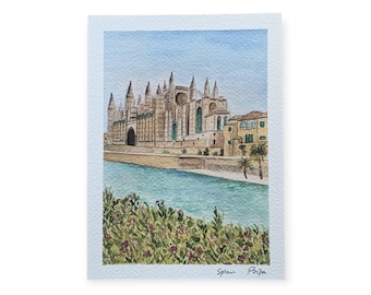 May include: Watercolour painting of a Spanish cathedral, set against a light blue sky and turquoise water. The cathedral is beige with multiple spires. Green and purple foliage in the foreground. The text "Spain Palma" is in the bottom right corner.