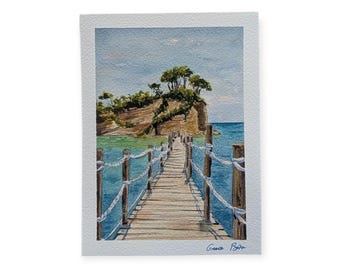 May include: Watercolor painting of a wooden bridge leading to a small island with trees. The bridge has rope railings and wooden posts. The water is a vibrant turquoise, and the sky is a light blue. The painting is signed "Greece Boto".