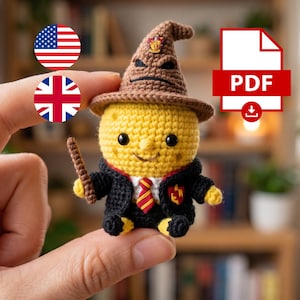 May include: A small, yellow, crocheted figure wearing a brown pointed hat with a face, a black robe, a white shirt, and a red and gold striped tie. The figure holds a brown wand and features a small red and gold emblem on the robe.