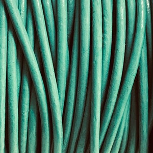 May include: A close-up of a bundle of teal blue licorice ropes.