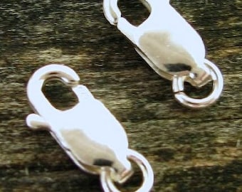 May include: Two silver-toned lobster claw clasps with a polished finish. The clasps are designed to be used for jewelry making or other crafting projects.