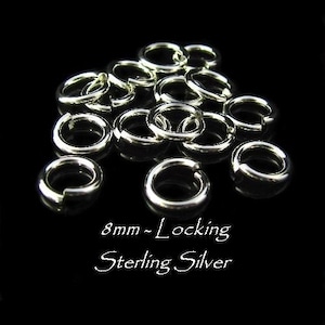 May include: A close-up of a pile of 8mm silver locking jump rings. The rings are made of sterling silver and are perfect for jewelry making.