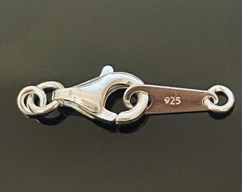 May include: Silver clasp with a lobster claw closure and a spring ring. The clasp is marked with the number "925", indicating that it is made of sterling silver.