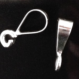 May include: Two silver-toned pendant bails, one with a loop and the other with a flat, pointed end.