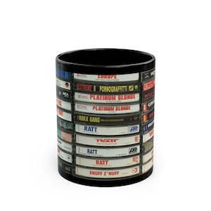 May include: Black coffee mug with a design of vintage cassette tapes featuring band names like Europe, Extreme, Platinum Blonde, Roxxy Gang, Ratt, and Enuff Z'nuff.