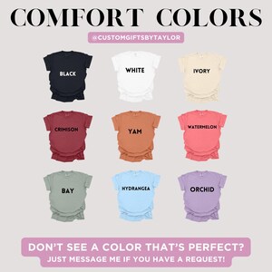 May include: A display of nine Comfort Colors t-shirts in various colors, including black, white, ivory, crimson, yam, watermelon, bay, hydrangea, and orchid. The text "COMFORT COLORS" and the seller's Instagram handle are at the top. The bottom text reads "DON'T SEE A COLOR THAT'S PERFECT? JUST MESSAGE ME IF YOU HAVE A REQUEST!"