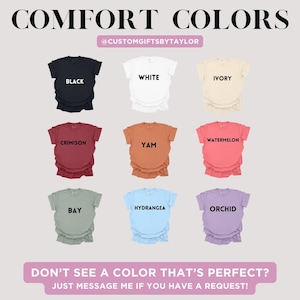 May include: A display of nine t-shirts in various colors, including black, white, ivory, crimson, yam, watermelon, bay, hydrangea, and orchid. The text "COMFORT COLORS" is at the top, with the seller's Instagram handle below. The bottom text reads, "DON'T SEE A COLOR THAT'S PERFECT? JUST MESSAGE ME IF YOU HAVE A REQUEST!"