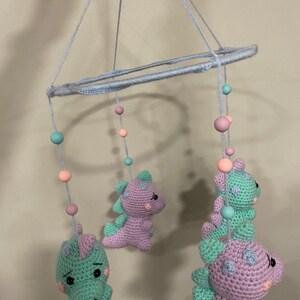 かぎ針編みの赤ちゃん用恐竜モビールとお揃いのガラガラ