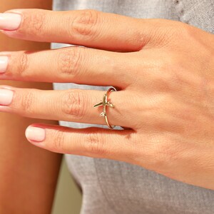 Celebrate your love for adventure with our traveler ring gold, a sleek and meaningful accessory for those always on the move. This stylish airplane ring 14K and Airplane ring gold design is perfect for any female pilot ring or aviation enthusiast. With its minimal plane ring design and elegant 18K stackable ring form, it's ideal for everyday wear. Whether you're looking for something gifted for hostess, travellers jewelry,