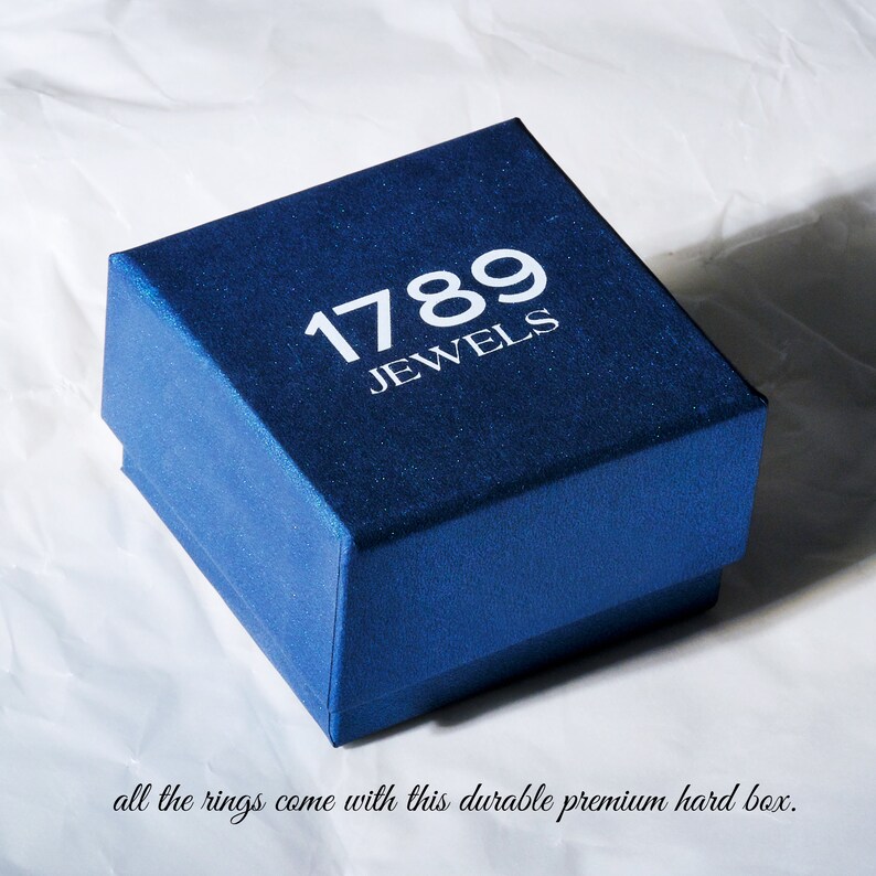 May include: A blue jewelry box with the text "1789 Jewels" printed on the top.