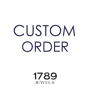 May include: White background with the words "CUSTOM ORDER" in navy blue, with the text "1789 JEWELS" in black below. The text is centered, suggesting a custom jewelry service.