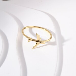 Celebrate your love for adventure with our traveler ring gold, a sleek and meaningful accessory for those always on the move. This stylish airplane ring 14K and Airplane ring gold design is perfect for any female pilot ring or aviation enthusiast. With its minimal plane ring design and elegant 18K stackable ring form, it's ideal for everyday wear. Whether you're looking for something gifted for hostess, travellers jewelry,