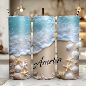 May include: Three stainless steel tumblers with a beach scene design. The tumblers feature a blue ocean with white waves crashing on a sandy beach. The beach is decorated with seashells and starfish. The middle tumbler has the name "Amelia" written on it.