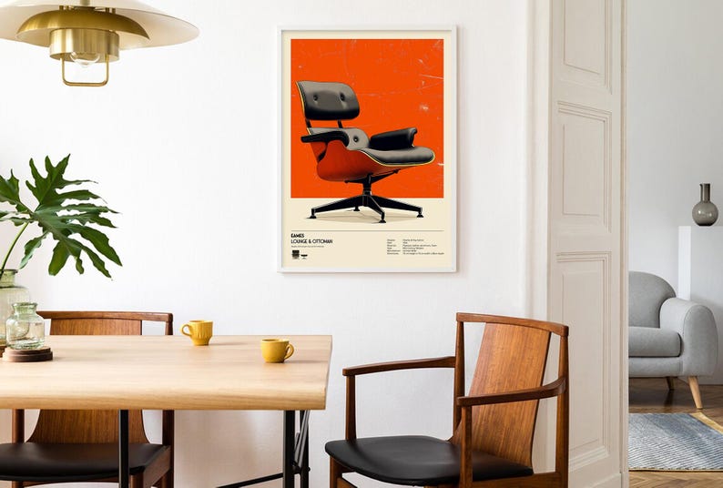 May include: A framed poster featuring a mid-century modern chair design against an orange background. The chair is black and red, with a black base. The poster is displayed on a white wall in a dining room setting.