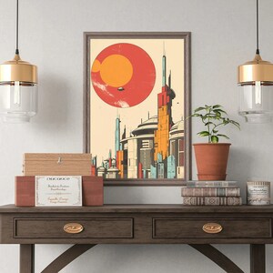 May include: A framed illustration of a futuristic city with a large red and orange planet in the background. The illustration is hanging on a wall above a wooden table with two drawers. There are two gold pendant lights hanging above the table, and a potted plant and a stack of books are on the table.