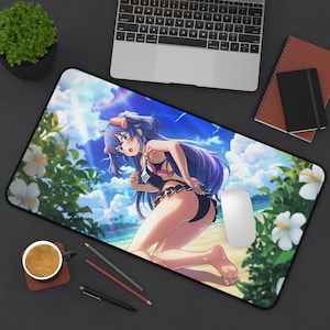 May include: A rectangular desk mat featuring a vibrant anime-style illustration of a character with long purple hair and animal ears, kneeling on a sandy beach. The scene includes white hibiscus flowers, a bright blue sky, and a tropical ocean backdrop.