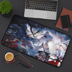 May include: Large rectangular mousepad featuring a detailed anime-style illustration of a character with white hair and a sword. The design incorporates shades of blue, white, and red, with a black border. A laptop, notebook, and coffee cup are also visible.