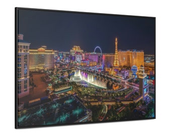 May include: A nighttime aerial view of the Las Vegas skyline, featuring the Bellagio fountains, the High Roller observation wheel, and several illuminated casinos and hotels.