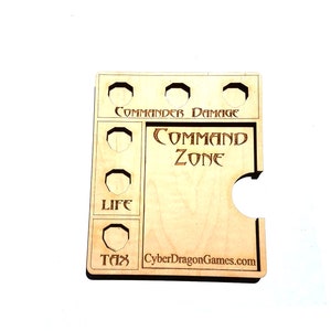 Puede incluir: Tablero de juego de madera con recortes para dados y fichas. El tablero tiene etiquetas para "Commander Damage", "Command Zone", "Life" y "Tax". El tablero también tiene el texto "CyberDragonGames.com".