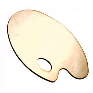 Puede incluir: Paleta de artista de madera, de forma ovalada con un agujero para el pulgar y un borde curvado para sujetarla. La paleta es de madera clara, con vetas visibles. El fondo es blanco.