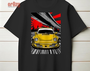 May include: A black t-shirt featuring a graphic of a yellow sports car driving under a bridge. The car is in the foreground and the bridge is in the background. The graphic is in a cartoon style.