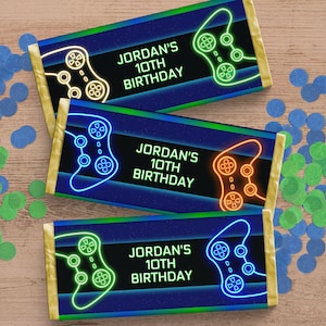 May include: Three blue, green, and orange gamer-themed chocolate bar wrappers with neon green, blue, and orange video game controllers and the text "JORDAN'S 10TH BIRTHDAY".