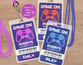 May include: Three blue and white plastic party favour badges with a neon pink, blue, and red video game controller graphic. The text "GAME ON!" is at the top of each badge. The text "AVERY'S 9TH BIRTHDAY" is in the middle of each badge. The text "VIP ALL ACCESS PASS" is at the bottom of each badge. The names "EMILY", "RILEY", and "AVERY'S 9TH" are at the bottom of each badge.