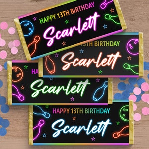 May include: Four black and neon-coloured chocolate bar wrappers with a bowling theme. The wrappers have a gold border and feature the text "Happy 13th Birthday Scarlett" and "15th Birthday Scarlett".