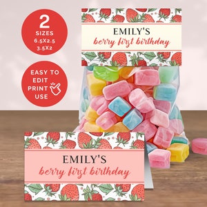 May include: Printable party favor tags with a strawberry pattern and the text "EMILY'S berry first birthday". The tags are pink with white text and are available in two sizes: 6.5 x 2.5 inches and 3.5 x 2 inches.
