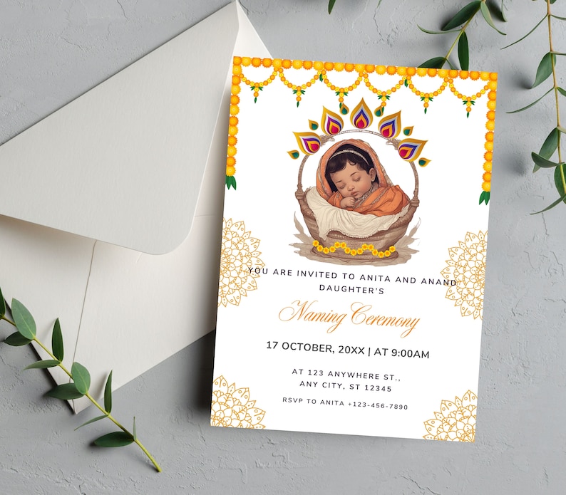 May include: A yellow and gold invitation card with a floral design. The card features a baby in a basket with a floral garland above. The text on the card reads "You are invited to Anita and Anand's Daughter's Naming Ceremony, 17 October, 20XX | At 9:00AM, At 123 Anywhere St., Any City, ST 12345, RSVP to Anita -123-456-7890".