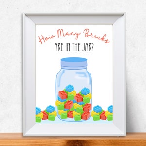 A framed picture of a jar filled with building bricks for a guess how many game.