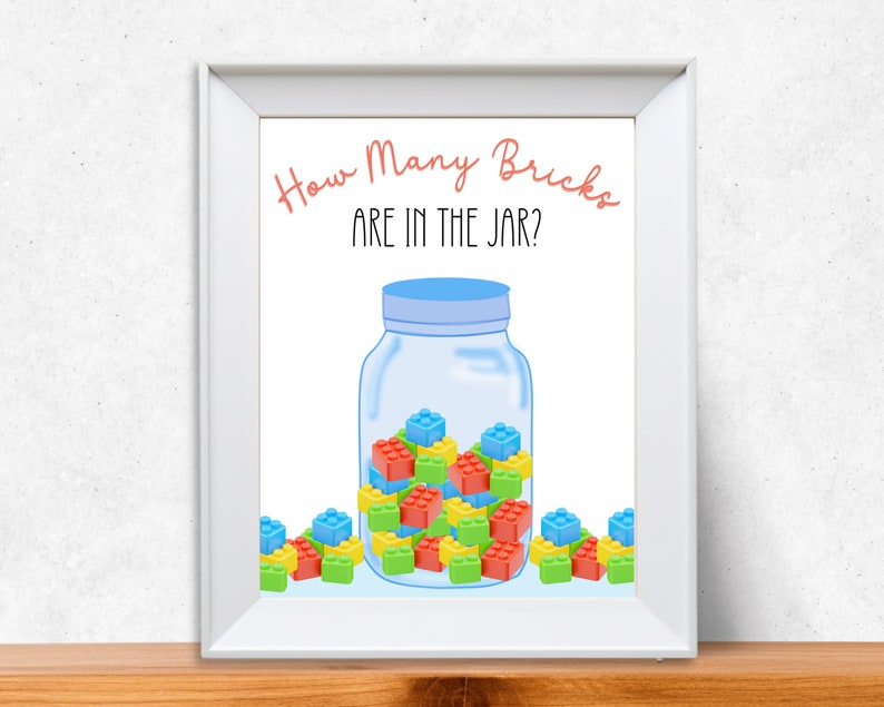 A framed picture of a jar filled with building bricks for a guess how many game.