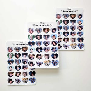 May include: Three sheets of stickers featuring photos of a K-pop boy band called "RIIZE" in heart-shaped frames. The text "#RIIZE Hearts" is printed on each sheet.