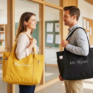 May include: Two tote bags, one mustard yellow and one black, are shown. The yellow bag has "Miss Emma" embroidered on it, and the black bag has "Mr. Ryan" embroidered on it. Both bags have multiple pockets and are carried by people.