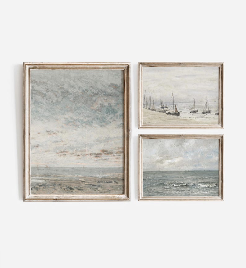 May include: Three framed paintings depicting seascapes. The top left painting shows a cloudy sky over a sandy beach. The top right painting shows a group of sailboats on a calm body of water. The bottom painting shows a stormy sea with waves.