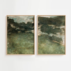 May include: Two framed abstract landscape paintings with a green and blue color scheme. The paintings are in wooden frames and are hanging on a white wall.