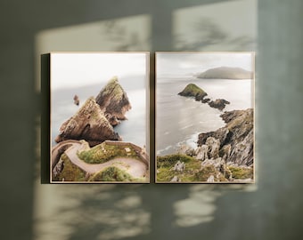 May include: Two framed photographs of a rocky coastline with a winding road leading to a small island. The photos are in a muted color palette with a soft, natural light.