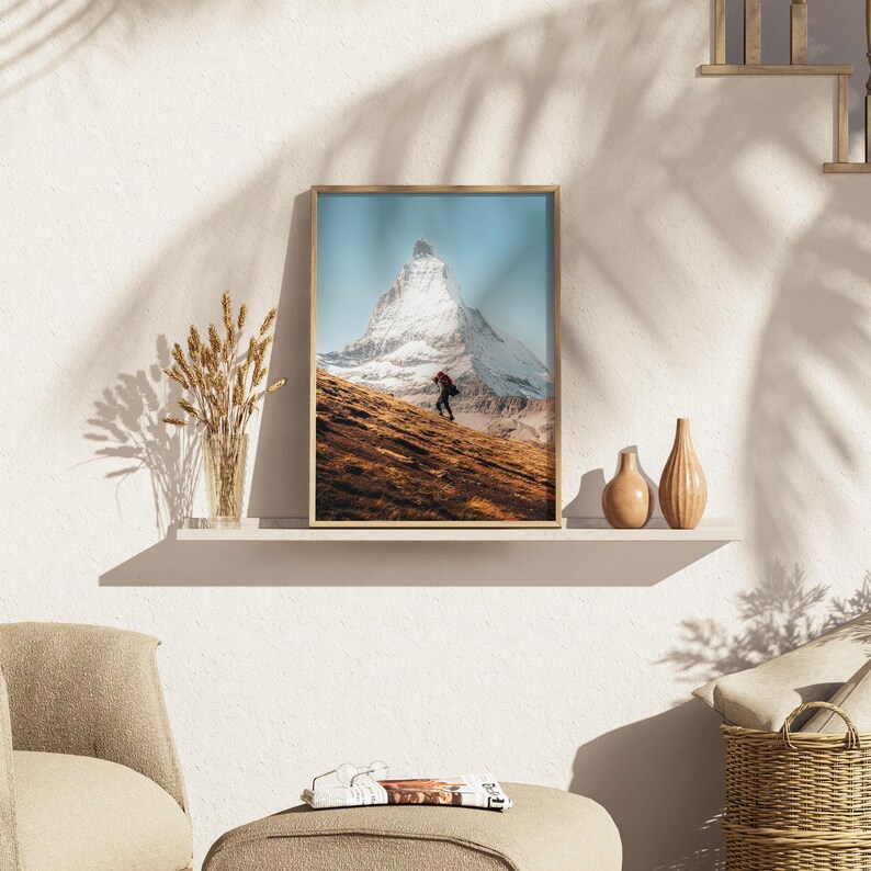 Create a gallery wall that tells a story with this majestic Matterhorn artwork, highlighting the scenic beauty of a lone hiker against the iconic peak.