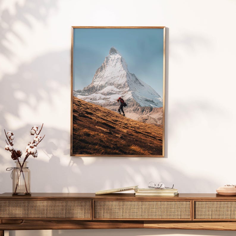 Unveil the captivating allure of the Matterhorn with this wall art, featuring a lone adventurer against the backdrop of the iconic mountain peak.