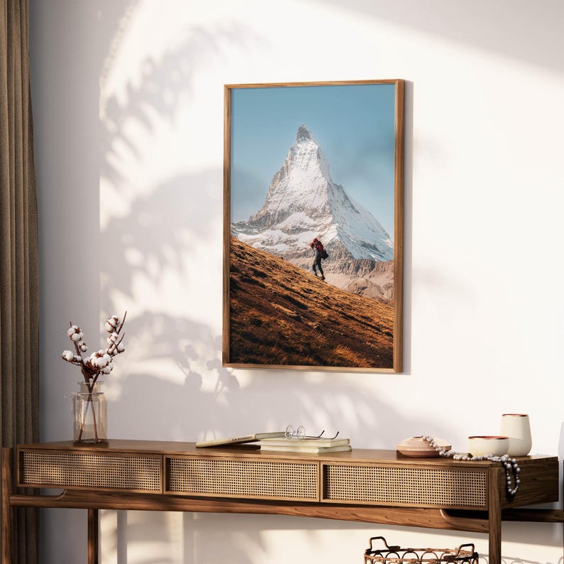 Transport yourself to tranquility with this unframed Matterhorn wall art, beautifully portraying a solitary trekkers contemplative journey.