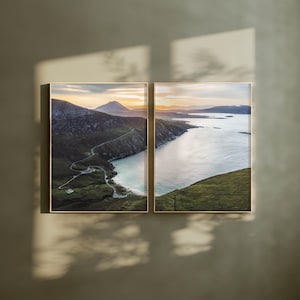 May include: Two framed landscape photographs of a winding road leading to a bay with a small beach. The photos are taken from a high vantage point and show a scenic view of the coastline.